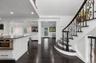 Entrance foyer featuring a decorative wall, dark wood-type flooring, wainscoting, crown molding, and recessed lighting