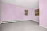 Empty room with baseboards and a baseboard radiator