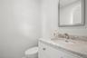Bathroom featuring toilet, vanity, and baseboards