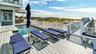 Deck with outdoor dining space and a water view