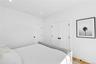 Bedroom with wood finished floors, recessed lighting, and a closet