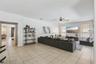 Second living space open to kitchen with TV and room for a large family to relax or entertain.