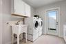 Laundry room with utility sink and doors to outdoor shower