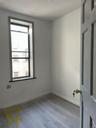 Spare room with baseboards and light wood-type flooring