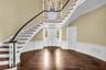 Foyer- beautiful hardwood floors, exquisite woodwork detail and lots of natural light throughout