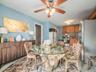 Dining room with light tile patterned floors and ceiling fan