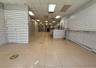 Hall with a drop ceiling and light tile patterned floors