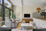 The impressive living room offers a wonderful sense of openness while maintaining just the right amount of separation from the kitchen and dining area