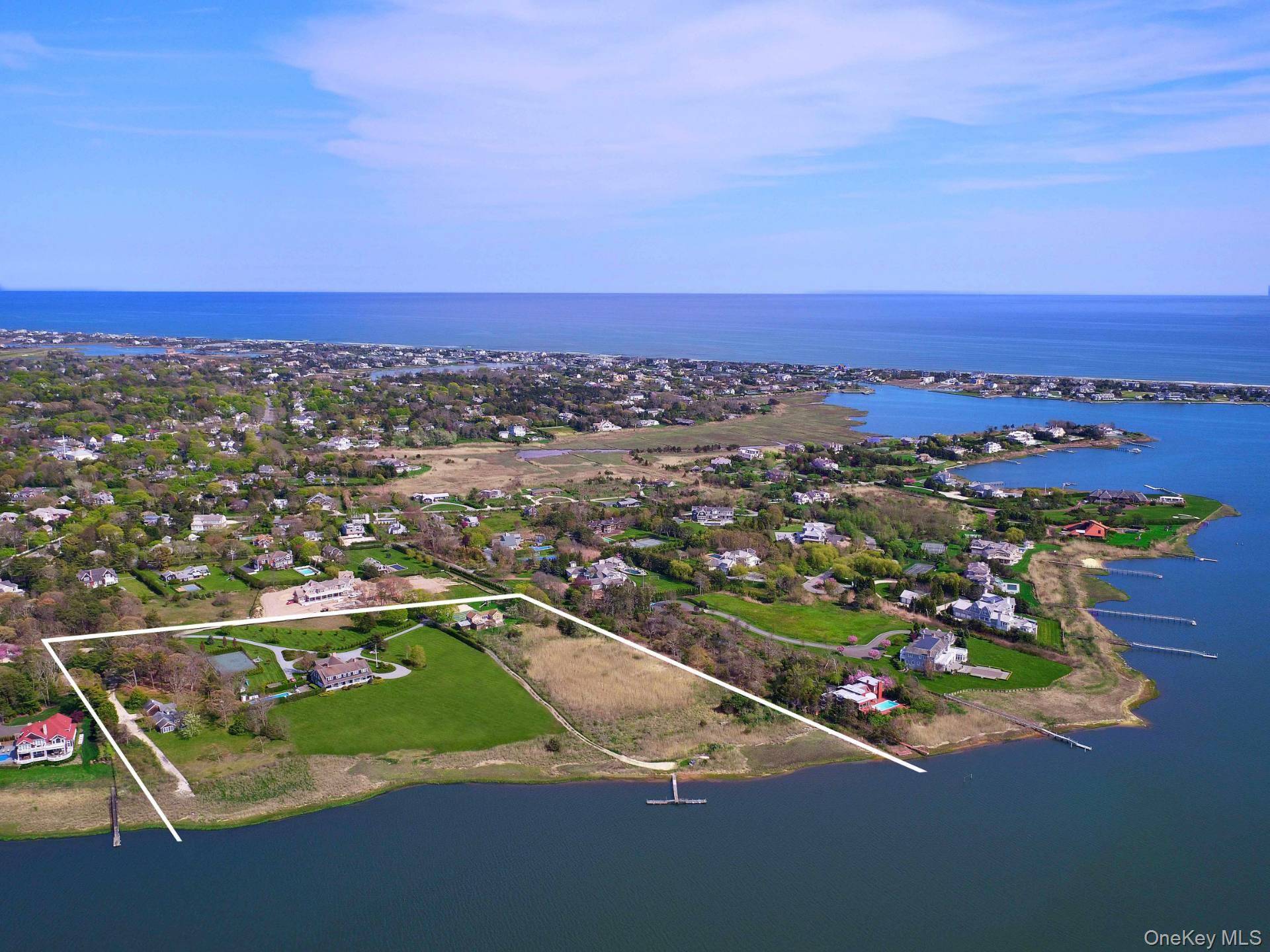 Welcome to a palatial bay front estate at 4 Sandacres Road, Quogue, NY, where elegance meets casual luxury.