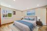 Bedroom featuring baseboard heating, light wood-style flooring, and recessed lighting