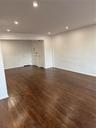 Spare room with recessed lighting, dark wood-style floors, and baseboards