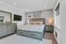 Bedroom featuring wood-finish flooring, recessed lighting, crown molding, and two windows with electric blinds