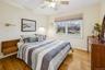 Bedroom 3 with light wood-style flooring and a ceiling fan