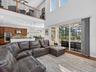 Family room with view into the kitchen and cafe. Loft is observed overhead.