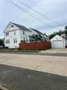 View of home's exterior with a garage, an outbuilding, and driveway