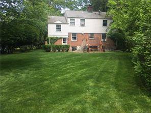 Charming four bedroom brick and vinyl clapboard colonial with terrace with gas grill and a large flat backyard on a level 0.