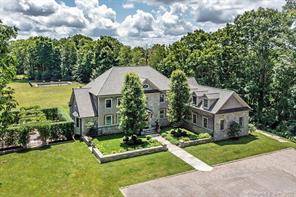 Private stone and shingle residence on 20 acres with large open lawn, blue stone terrace and garden.