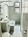 Bathroom with vanity, a wealth of natural light, tile patterned flooring, and tile walls