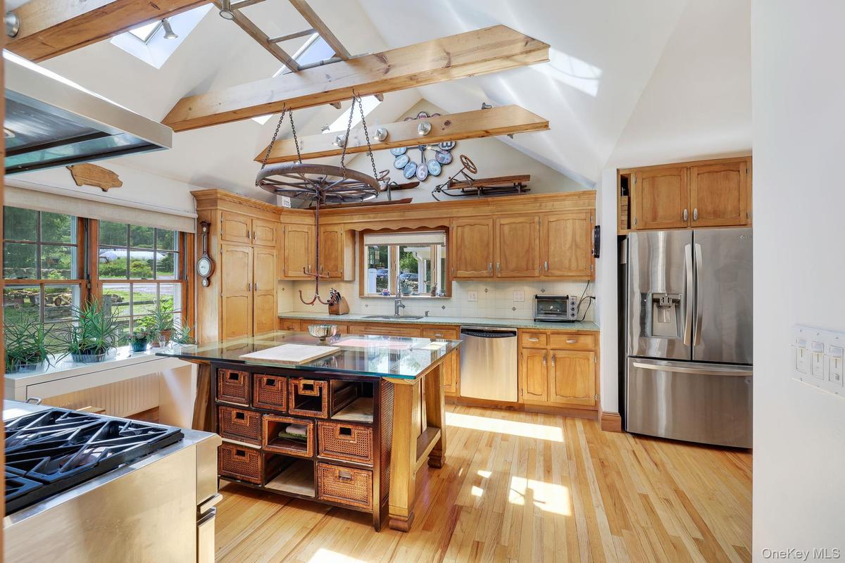 Kitchen with vaulted ceilings, exposed wood beams and skylights.