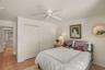 Comfortable guest bedroom featuring tile flooring and a spacious closet