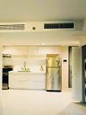Kitchen with stainless steel appliances, white cabinetry, modern cabinets, exhaust hood, and stacked washer / drying machine