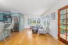 Living area featuring baseboards, light wood-type flooring, and recessed lighting