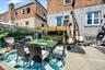 Outdoor patio space featuring a built-in bar, and privacy screening