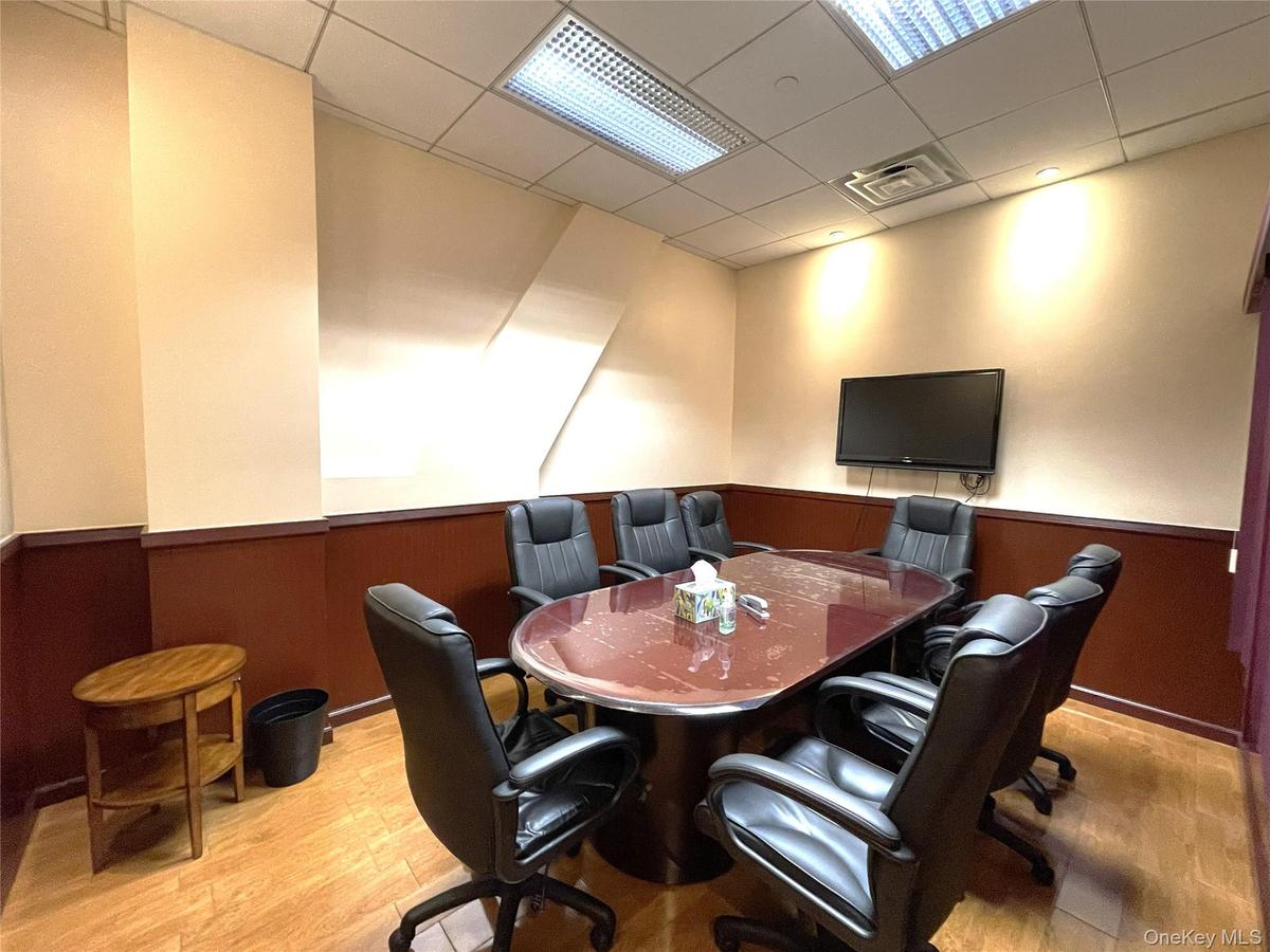 Home office featuring wainscoting, a paneled ceiling, and wood walls
