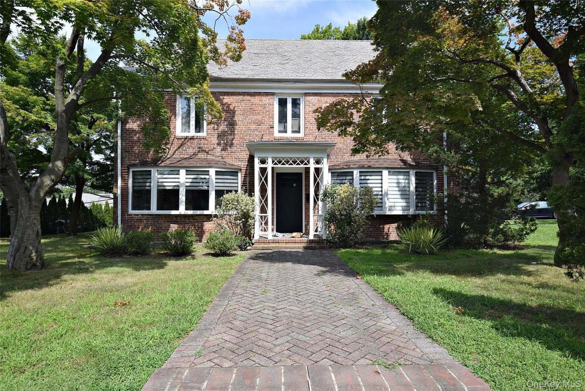 Brick exterior with a gabled roof and bay windows