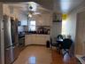 Kitchen featuring white cabinetry, ceiling fan, stainless steel appliances, tasteful backsplash, and light tile patterned floors