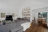 Living room featuring high vaulted ceiling and dark wood finished floors