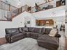 Family room with view into the kitchen and cafe. Loft is observed overhead.