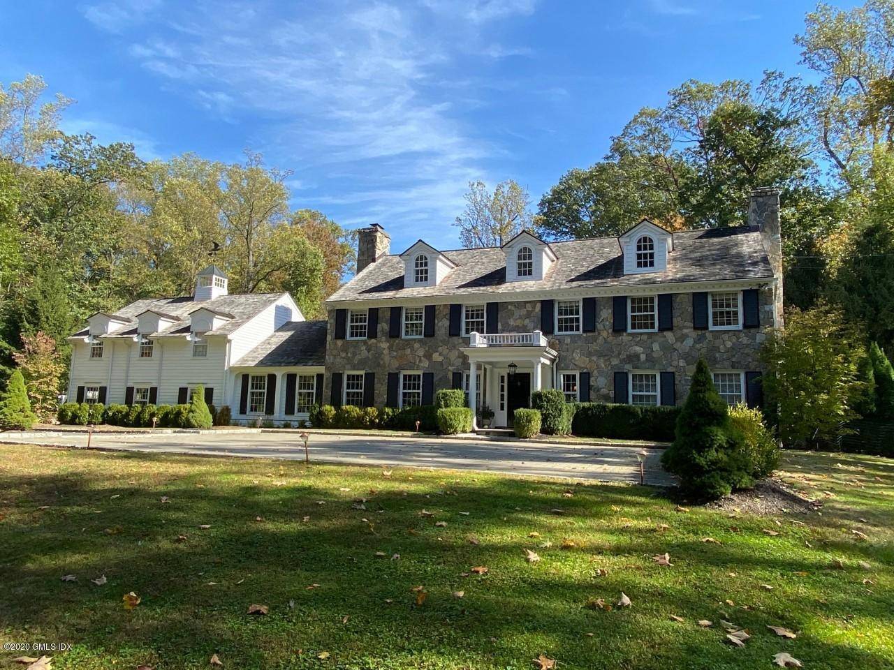 Handsome stone and clapboard colonial in a quiet private setting at the end of a cul de sac in mid country with heated pool and expansive backyard.