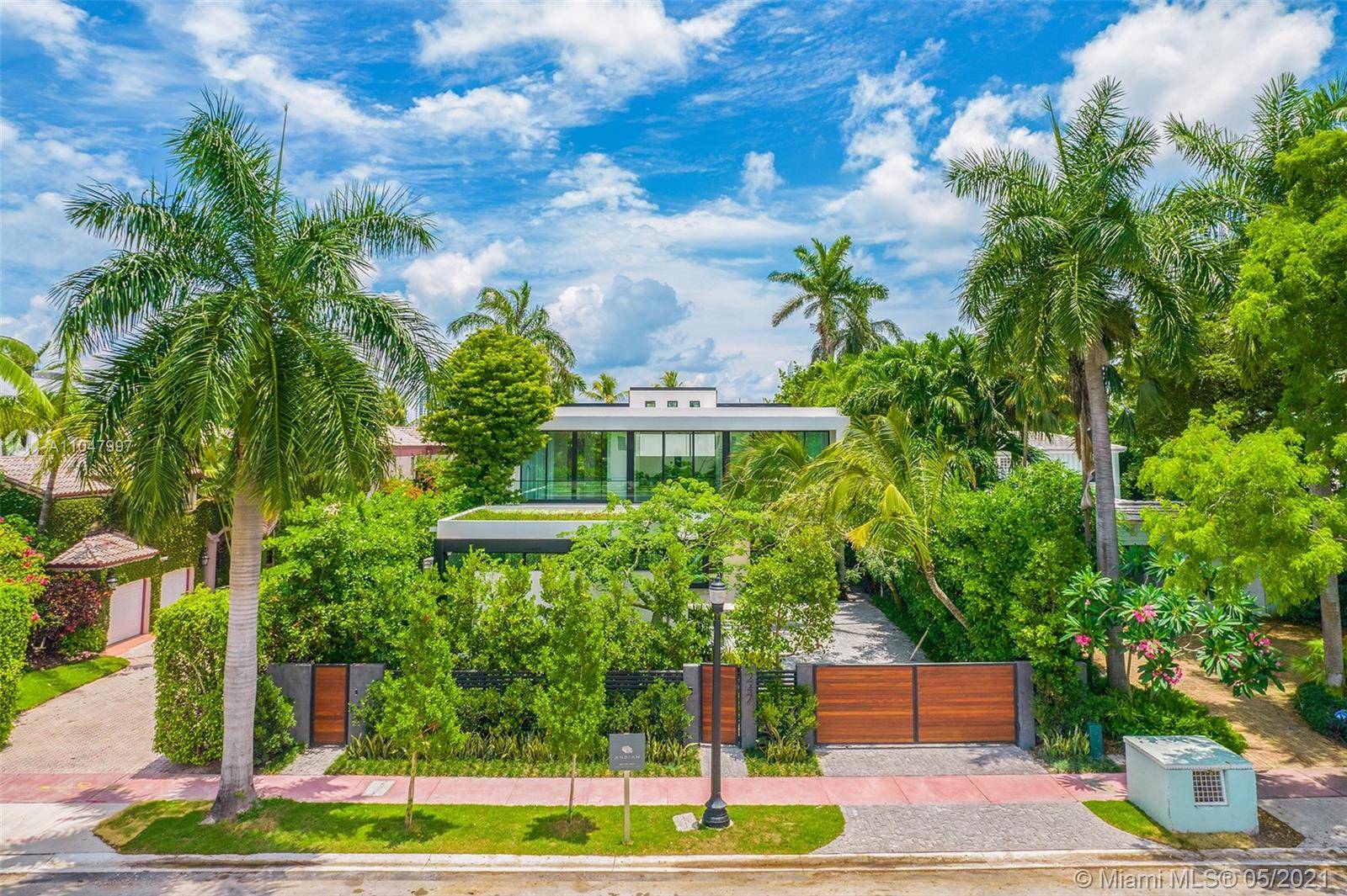 An extraordinary modern waterfront estate offers a completely custom living experience where every space was created to achieve a resort like lifestyle bursting with amenities.