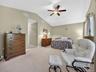 Primary bedroom suite includes two walk-in closets and ceramic tiled bathroom with soaking tub, seperate shower, and discreet lavatory.