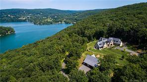 Modern Hilltop Retreat Brilliantly designed home on 30 acres affording complete privacy and jaw dropping views overlooking Lake Waramaug.