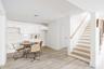 Dining space featuring light wood-style flooring, stairs, and baseboards