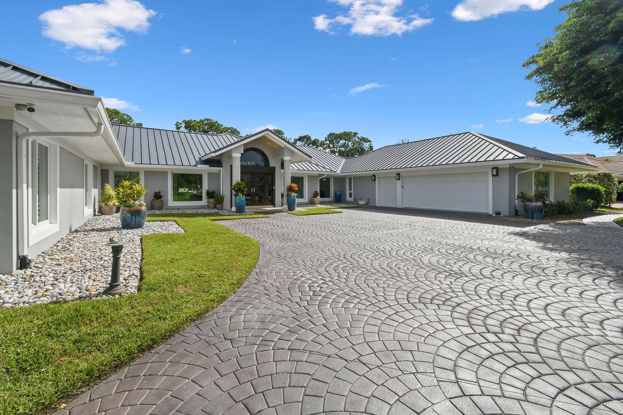 Experience luxury living at its finest in this fully reimagined CBS single story golf course home in the prestigious 'Harbour Village' neighborhood of Harbour Ridge Yacht Country Club.
