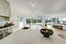 Kitchen with high end range, decorative light fixtures, plenty of natural light, and sink