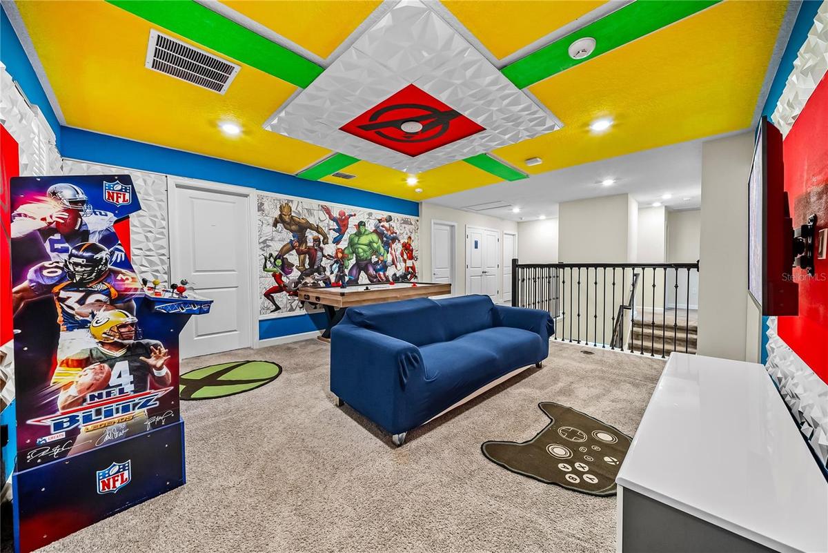 Avengers themed arcade game room with arcade games, pool table, smart TV