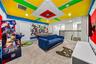 Avengers themed arcade game room with arcade games, pool table, smart TV