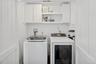Washroom with cabinet space and independent washer and dryer