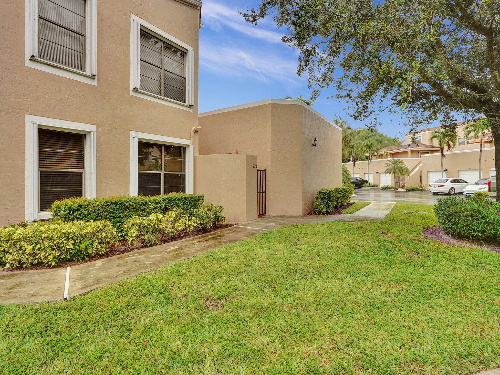 Pristine 3 bed 2 bath updated coach home style corner residence in Boca Raton's premier gated community of Boca Pointe in A RATED School District.