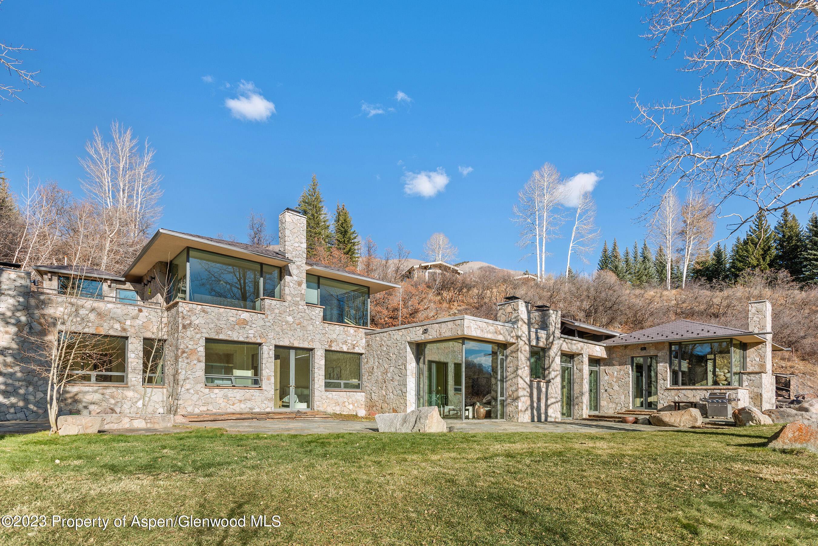 Stunning mountain panoramas are framed in the floor to ceiling windows throughout this home.