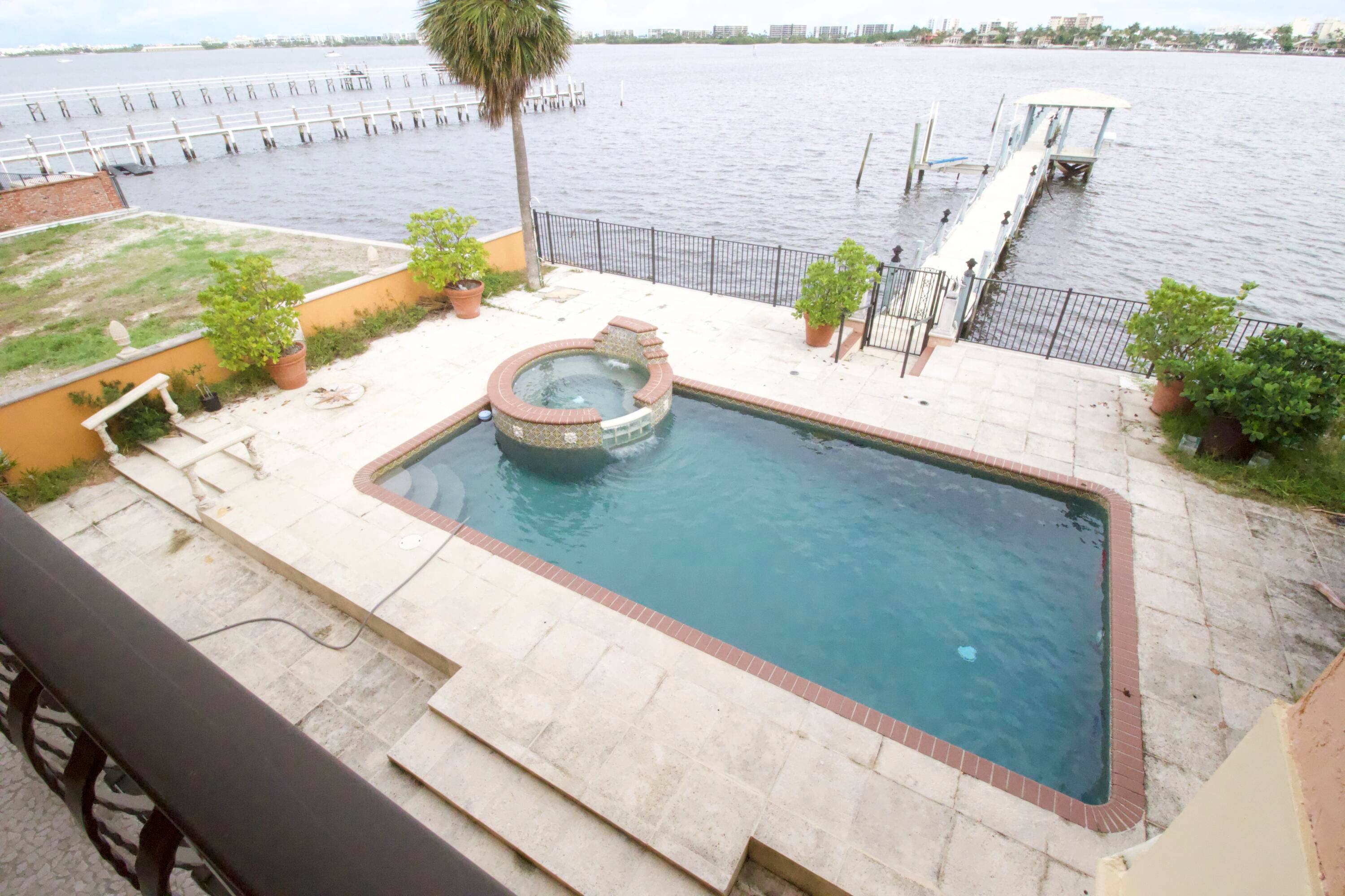 Furnished seasonal, 250 ft dock, accomodates a 50ft boat, 4 bedrooms, 4 bathrooms, gated entrance to the property, 2 car garage, ONLY 1.