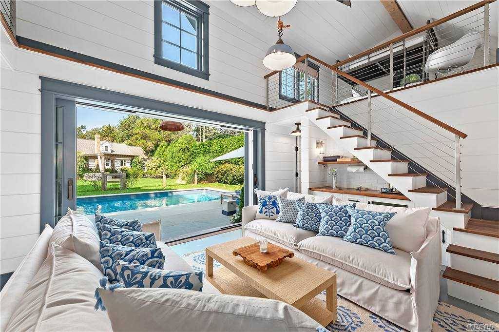 This beach vibe home with pool and newly built pool house is located in the Southampton Shores beach community.