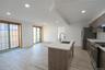 Kitchen featuring recessed lighting, light wood-type flooring, light stone countertops, an island with sink, and appliances with stainless steel finis