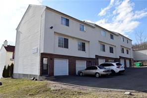 This 2 bedroom townhouse style end unit condo features a living room with a fireplace and sliders to a balcony.