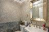 Bathroom with crown molding, sink, and toilet