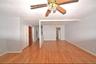 3rd Floor living room featuring light wood-style floors, a living room chandelier, and a ceiling fan